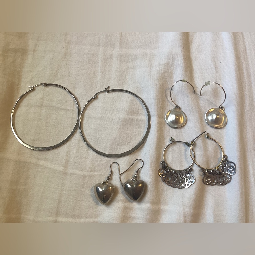 Four Silver-tone Earrings On Different Sizes